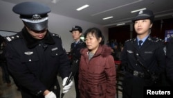 Zhang Shuxia, an obstetrician involved in baby trafficking, stands trial in Weinan Intermediate People's Court in Weinan, Shaanxi province, Dec. 30, 2013. 