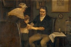 برطانوی ڈاکٹر ایڈورڈ جینر ایک بچے کو چیچک سے بچاؤ کی ویکسین لگا رہے ہیں۔ یہ ویکسین چیچک زدہ گائے کی پیپ سے تیار کی گئی تھی۔