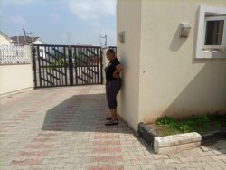 FILE - Torkwase Kuraun stands at the spot were her brother, Tordue Salem, was standing the morning of Oct. 13, 2021, the she last time she saw him, Nov. 4, 2021. (T. Obiezu/VOA)