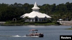 A search boat passes Disney's Fairy Tale Weddings Chapel in the Seven Seas Lagoon, located near the Grand Floridian, as police hunted for signs of a 2-year-old boy who was dragged by an alligator into the lagoon at the Walt Disney World resort in Orlando, Florida, U.S., June 15, 2016. REUTERS/Adrees Latif 