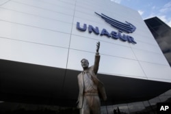 The statue of former Argentinian President Nestor Kirchner stands at the entrance to the Union of South American Nations, UNASUR, building, near Quito, Ecuador, Dec. 19, 2018. (AP Photo/Dolores Ochoa)