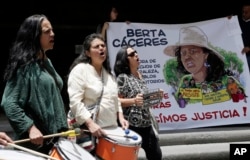 Women demanding justice for the slaying of Honduran Indian leader Berta Caceres play drums during a demonstration at the entrance of the Honduran Embassy in Quito, Ecuador, March 4, 2016.
