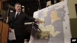Dallas Mayor Mike Rawlings points to a map showing Dallas County and the aerial spraying against mosquitos during a news conference in Dallas, Aug. 17, 2012.