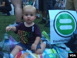 A toddler at the gathering outside the Dr Phillips Center for Performing Art in Orlando for a vigil for the victims and the injured of Orlando nightclub shooting. (S. Dizayee/VOA)