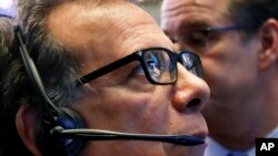 The NYSE and Yeti logos are reflected in the glasses of trader Sal Suarino as he works on the floor of the New York Stock Exchange, Oct. 25, 2018. 