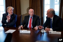 Rep. Kevin Brady, R-Texas, center, listens as President Donald Trump speaks to Sen. Bob Casey, D-Pa., during a meeting with lawmakers about trade policy in the Cabinet Room of the White House, Feb. 13, 2018.
