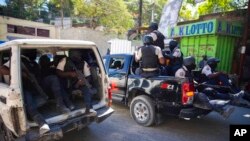 FILE - Police patrol after recovering the bodies of at least two journalists slain by gangs in Port-au-Prince, Haiti, Jan. 7, 2022. Canadian Prime Minister Justin Trudeau said Jan. 21, 2022, that Haiti's allies must help tackle violence that is worsening its humanitarian crisis.