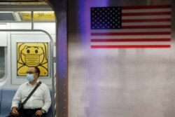 Seorang penumpang mengenakan masker saat di dalam kereta bawah tanah ketika jumlah kasus baru COVID-19 akibat varian Delta terus bertambah di Kota New York, AS, 26 Juli 2021. (Foto: Andrew Kelly/Reuters)