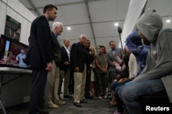 El vicepresidente de EE.UU., Mike Pence, habla con menores solicitantes de asilo en la instalación de procesamiento de la Patrulla Fronteriza en Donna, Texas, EE. UU., 12 de julio de 2019. REUTERS / Veronica G. Cardenas.