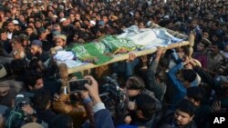 People attend a funeral of a Pakistani girl who was raped and killed, in Kasur, Pakistan, Jan. 10, 2018. Pakistani police said a mob angered over the crime attacked a police station in eastern Punjab province, triggering clashes that left at least two peo