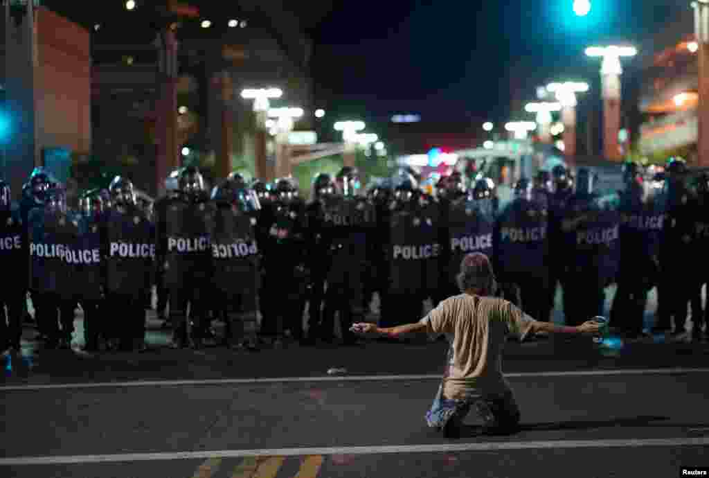 A demonstrator taunts Police officials after a Donald Trump campaign rally in Phoenix, Arizona, Aug. 22, 2017.