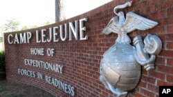 FILE - This photo, taken March 19, 2013, features a globe and anchor display at the entrance to Camp Lejeune, North Carolina.