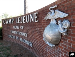 FILE - This photo, taken March 19, 2013, shows the globe and anchor sign at the entrance to Camp Lejeune, North Carolina.