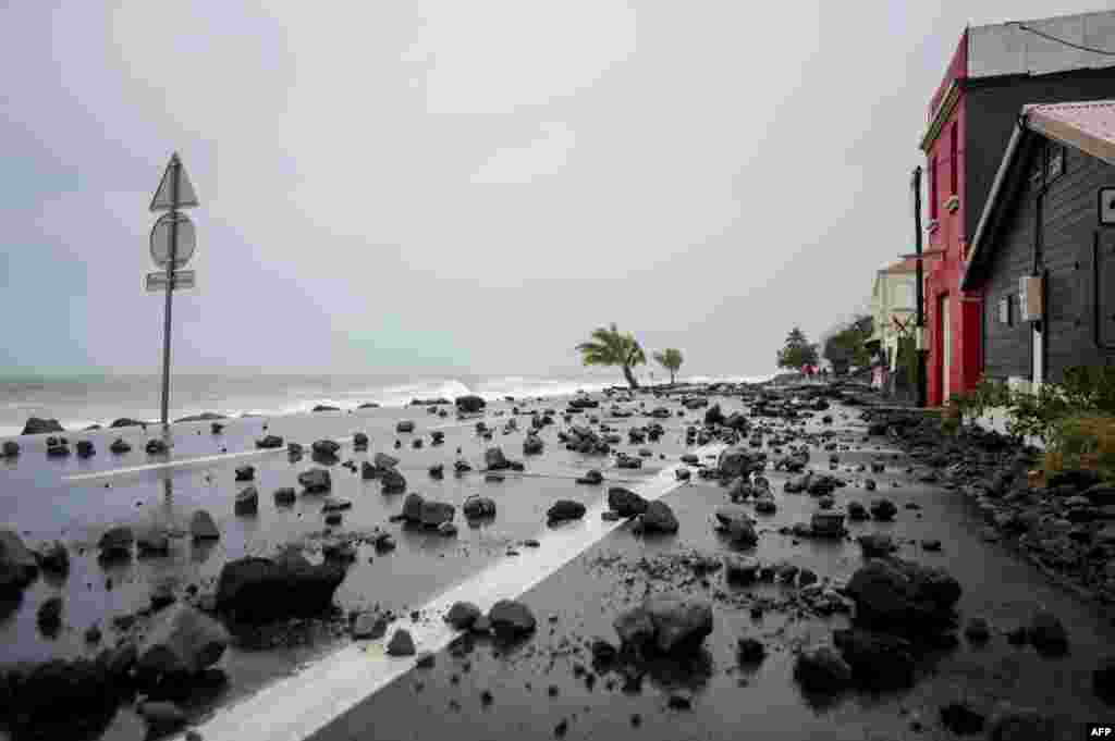 A picture shows rocks swept by strong waves onto a road in Le Carbet, on the French Caribbean island of Martinique, after it was hit by Hurricane Maria.
