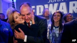 Louisiana Gov.-elect John Bel Edwards hugs his wife Donna Edwards as he arrives to greet supporters at his election night watch party in New Orleans, Nov. 21, 2015. 
