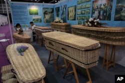 FILE - Wicker and seagrass coffins are displayed at the Asia Funeral and Cemetery Expo and Conference in Hong Kong, May 18, 2017. The expo underscores how Asia's rapidly aging population makes its death industry a potentially lucrative market.