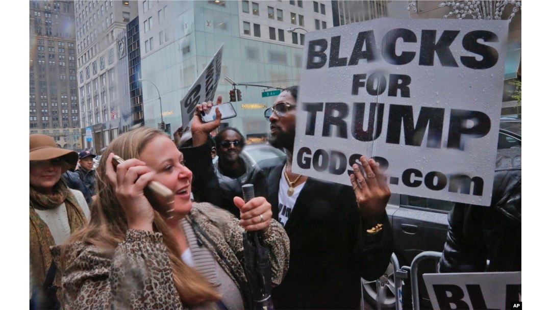 Pedestrians cheer as pro-Trump supporters, gather to voice their support for Trump's election as president, Nov. 9, 2016, outside Trump Tower in New York.