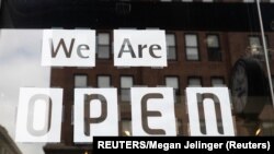 USA, Ohio, Columbus, A "we are open" sign is placed in the window of a restaurant 