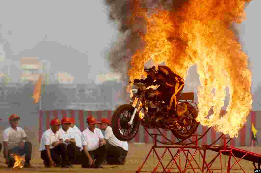 An member of the Indian army's 'Tornadoes' motorcycle display team rides during a combined display at an officer training academy in Chennai on March 9, 2018.