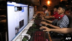 FILE - Myanmar youths browse their social media pages at an internet shop in Yangon, Dec. 18, 2018.