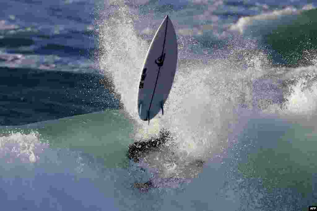 France surfer Marco Mignot rides a wave during the Men&#39;s QS 3,000 of the World Surf League SEAT Pro Netanya qualification in the Israeli coastal city of Netanya.