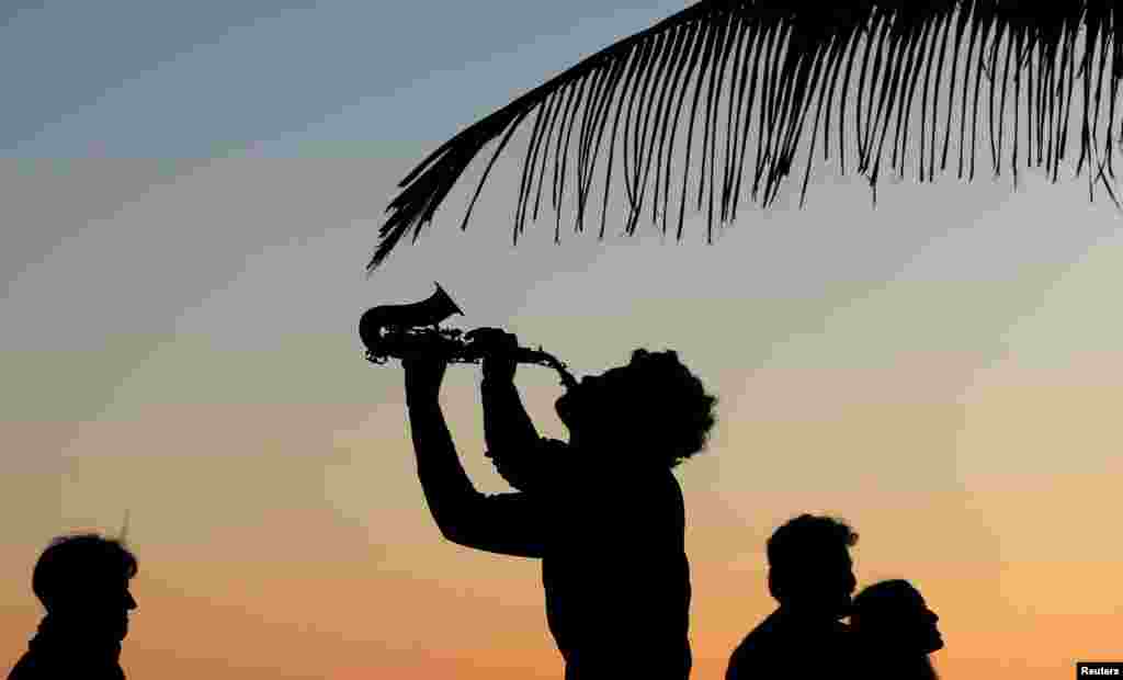 A man plays music near Arpoador beach in Rio de Janeiro, Brazil, Sept. 8, 2018.