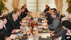 FILE - U.S. Defense Secretary Jim Mattis, third left, meets with Pakistani Prime Minister Shahid Khaqan Abbasi, fourth right, in Islamabad, Pakistan, Dec. 4, 2017.