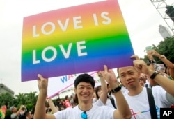FILE - Revelers participate in a gay pride parade in Taipei, Taiwan. Taiwan is shaping up become the first place in Asia to allow same-sex marriage.