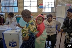 South Africans cast their votes at the Hitekani Primary School in Soweto, Johannesburg, May 8, 2019.