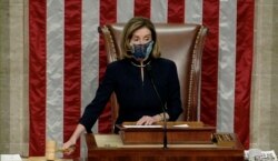 U.S. Speaker of the House Nancy Pelosi wields the gavel as House votes to impeach President Trump