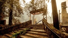 FILE - In this Sept. 28, 2020, file photo, a staircase remains at the Restaurant at Meadowood, which burned in the Glass Fire, in St. Helena, Calif. (AP Photo/Noah Berger, File