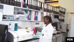 A lab technician assists in the superinfection study in Rakai, Uganda. (NIAID)
