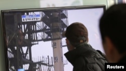 2012年12月12日，在韩国首尔火车站，人们观看电视播放朝鲜发射远程火箭的画面