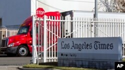 A truck is parked outside a Los Angeles Times facility in Los Angeles, Dec. 30, 2018. A computer virus hit the newspaper printing plant in Los Angeles, and at Tribune Publishing newspapers across the country. 