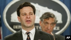 FILE - Then-Assistant Attorney General Christopher Wray speaks during a press conference at the Justice Department in Washington, Nov. 4, 2003. 