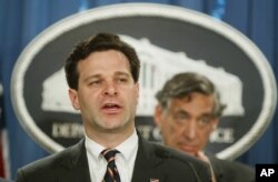 FILE - Then-Assistant Attorney General Christopher Wray speaks to the media at the Justice Department in Washington, Nov. 4, 2003.