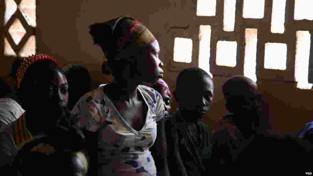 A girl stares out the window at Bossangoa chuch&#39;s Sunday prayers. Over 36,000 people are living at the site. (Hanna McNeish for VOA)
