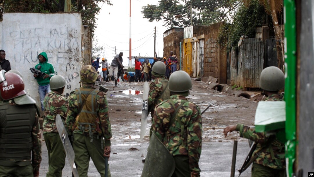 An opposition supporter throws a stone at riot police in Kibera Slums in Nairobi, Kenya, Thursday, Oct. 26, 2017.