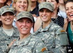 U.S. Army First Lt. Shaye Haver, center, and Capt. Kristen Griest, right, pose for photos with other female West Point alumni after an Army Ranger school graduation ceremony, Aug. 21, 2015, at Fort Benning, Ga.