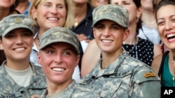 U.S. Army First Lt. Shaye Haver, center, and Capt. Kristen Griest, right, pose for photos with other female West Point alumni after an Army Ranger school graduation ceremony, Aug. 21, 2015, at Fort Benning, Ga. (AP Photo/John Bazemore)