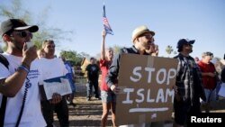 FILE - Demonstrators shout during a "Freedom of Speech Rally Round II" outside the Islamic Community Center in Phoenix, Arizona, May 29, 2015.