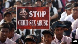 FILE - Indian schoolchildren participate in an awareness campaign rally to mark World Day for the Prevention of Child Abuse and Violence against Children, in Hyderabad, India, Nov. 19, 2014. 