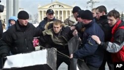 Belarusian plain clothes policemen detain Zmitser Dashkevich, center, opposition youth movement leader, during a protest action in downtown Minsk, Belarus, in this file photo from March 15, 2005.