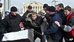 Belarusian plain clothes policemen detain Zmitser Dashkevich, center, opposition youth movement leader, during a protest action in downtown Minsk, Belarus, in this file photo from March 15, 2005. 