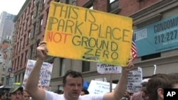 Protesters in New York City hold posters to express their opinions about the proposed Islamic Center to be built near the site of the September 11, 2001 terror attacks, 22 Aug 2010