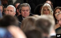 From left, Vice President Mike Pence, chief White House strategist Steve Bannon and presidential counselor Kellyanne Conway sit together in the audience during a joint news conference held by President Donald Trump and German Chancellor Angela Merkel in the East Room of the White House in Washington, March 17, 2017.