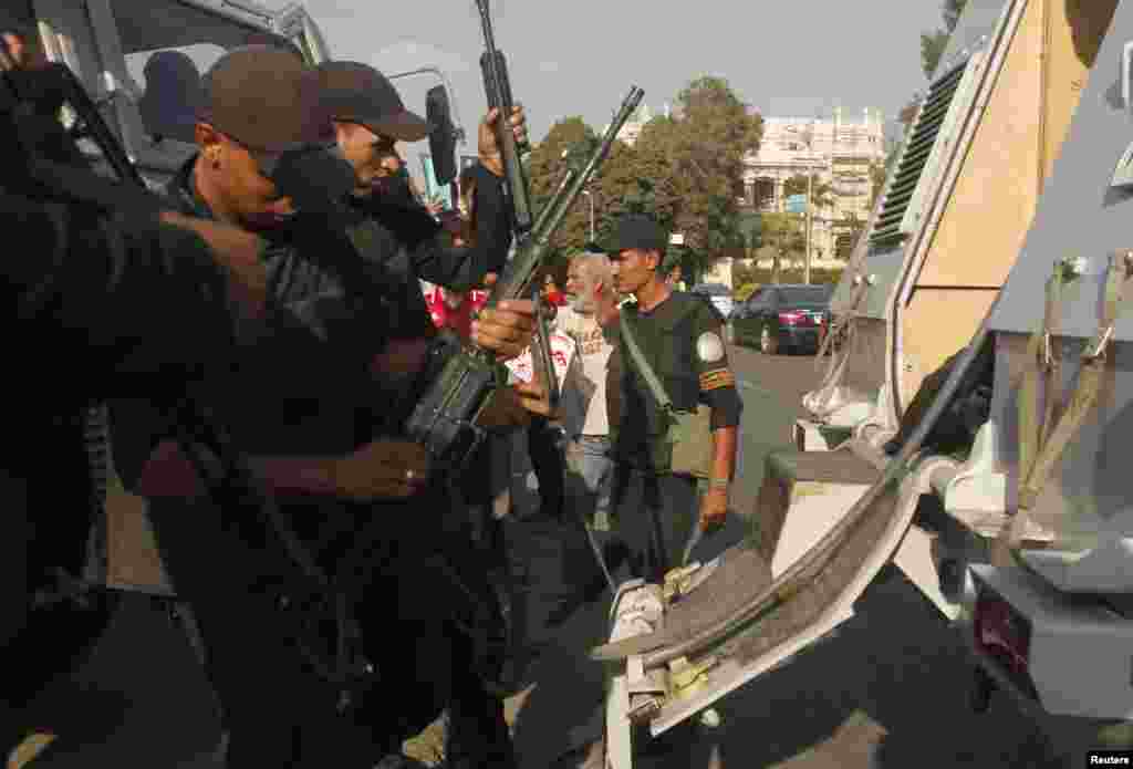 Police officers prepare after reports of a possible pro-Morsi rally, near Tahrir square in Cairo, July 23, 2013.