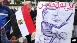 Egyptian children hold an anti-Mubarak cartoon during a protest in Alexandria, Egypt, February 4, 2011