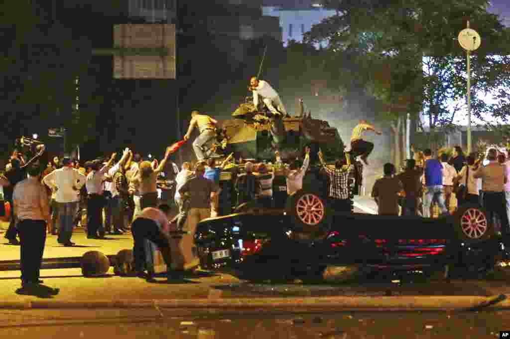 Tanks move into position as Turkish people attempt to stop them, in Ankara, Turkey, early Saturday, July 16, 2016.