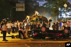 FILE - Tanks move into position as Turkish people attempt to stop them, in Ankara, Turkey, July 16, 2016.